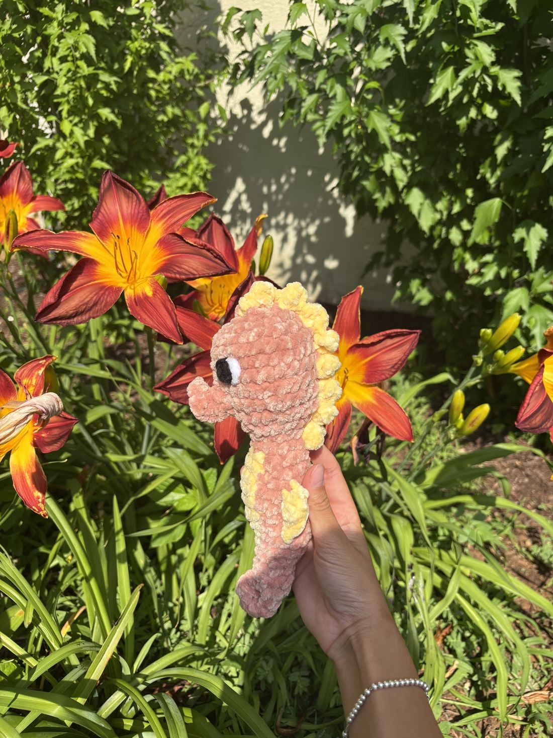 Handmade crochet seahorse in blush and yellow